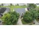 Aerial view of a two-story home featuring a gray roof, surrounded by mature trees in a residential neighborhood at 308 Sarasota Ln, Locust Grove, GA 30248
