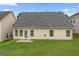 Spacious backyard with lush green lawn and view of the home's exterior at 308 Sarasota Ln, Locust Grove, GA 30248