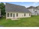 Spacious backyard with lush green lawn and view of the home's exterior at 308 Sarasota Ln, Locust Grove, GA 30248