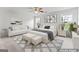 Staged bedroom featuring a sofa, bed, bench, windows, and carpeted floor at 308 Sarasota Ln, Locust Grove, GA 30248