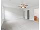 Bedroom featuring carpeted floor, ceiling fan, windows, and two closets at 308 Sarasota Ln, Locust Grove, GA 30248