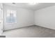 Bright bedroom with neutral carpet, complemented by a textured ceiling and natural light at 308 Sarasota Ln, Locust Grove, GA 30248