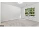 Bright bedroom with large window and neutral carpet flooring at 308 Sarasota Ln, Locust Grove, GA 30248