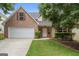 Charming two-story brick home featuring an attached two-car garage and a well-maintained front lawn and manicured landscaping at 308 Sarasota Ln, Locust Grove, GA 30248