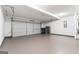 Spacious garage features concrete flooring, white walls, and large door at 308 Sarasota Ln, Locust Grove, GA 30248