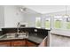 Kitchen area features granite countertops, stainless steel sink and faucet, and breakfast bar at 308 Sarasota Ln, Locust Grove, GA 30248