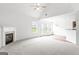 Open-concept living area with hardwood floors, fireplace, and natural light at 308 Sarasota Ln, Locust Grove, GA 30248