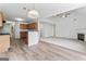 Open layout connecting kitchen and living room, featuring hardwood flooring and fireplace at 308 Sarasota Ln, Locust Grove, GA 30248