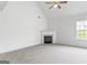 Bright living room featuring a fireplace and high ceilings at 308 Sarasota Ln, Locust Grove, GA 30248