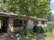 Brick home exterior featuring a mature tree in the front yard at 6337 Wellington Way, Austell, GA 30106