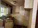 This outdated kitchen has cabinets with peeling paint and a stainless sink at 6337 Wellington Way, Austell, GA 30106