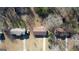 An aerial view of the home between two other homes in a wooded neighborhood at 11 Grove Ln, Hampton, GA 30228