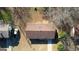 An aerial view of the home with a brown roof and a car in the driveway at 11 Grove Ln, Hampton, GA 30228