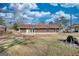 Scenic backyard showcasing lush greenery, mature trees, and a partial view of the house and property line at 11 Grove Ln, Hampton, GA 30228