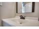 Close up of the bathroom sink and a mirror with a view through the doorway at 11 Grove Ln, Hampton, GA 30228