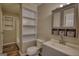 Bathroom with ample storage shelves, a stylish vanity, and a toilet, maximizing functionality at 11 Grove Ln, Hampton, GA 30228