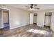 This bedroom features wood-look floors, ceiling fan, and a closet, all illuminated with an abundance of natural light at 11 Grove Ln, Hampton, GA 30228
