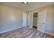 A well-lit bedroom showcases a closet, wood-look flooring, and neutral walls, offering a serene space at 11 Grove Ln, Hampton, GA 30228