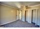 Bedroom featuring carpet flooring, closet doors, and a view into the adjacent kitchen at 11 Grove Ln, Hampton, GA 30228