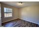 This bedroom features wood-look floors and a window, all illuminated with an abundance of natural light at 11 Grove Ln, Hampton, GA 30228