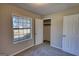This bedroom features carpet and a closet, all illuminated with an abundance of natural light from the window at 11 Grove Ln, Hampton, GA 30228