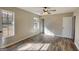 This bedroom features wood-look floors and a closet, all illuminated with an abundance of natural light from the window at 11 Grove Ln, Hampton, GA 30228