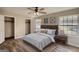 This bedroom features wood-look floors, ceiling fan, two closets, and an abundance of natural light from the window at 11 Grove Ln, Hampton, GA 30228