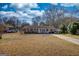 A charming single-story brick home featuring a well-maintained lawn and classic architectural details at 11 Grove Ln, Hampton, GA 30228