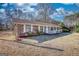 A brick home with white trim, complemented by fresh landscaping and a well-maintained lawn at 11 Grove Ln, Hampton, GA 30228