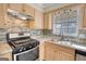 Updated kitchen features stainless steel appliances and natural wood cabinetry at 11 Grove Ln, Hampton, GA 30228
