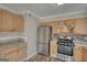 Charming kitchen featuring stainless steel appliances, wood cabinets, tile backsplash and wood-look flooring at 11 Grove Ln, Hampton, GA 30228
