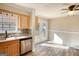 Sunlit kitchen nook with stainless steel appliances, tile backsplash, and French doors to the backyard at 11 Grove Ln, Hampton, GA 30228