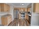 Well-lit kitchen boasts stainless steel appliances, stone backsplash, and ample cabinet space at 11 Grove Ln, Hampton, GA 30228