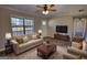 Bright living room showcases a large window, plush sofa and stylish decor at 11 Grove Ln, Hampton, GA 30228