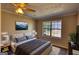 Cozy main bedroom with neutral colors, a large window, and a ceiling fan at 11 Grove Ln, Hampton, GA 30228