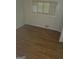 Inviting bedroom showcasing hardwood floors, a window, and neutral wall paint at 2527 Amalfi Dr, Conyers, GA 30012