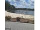 Beautiful lake view highlighting the serene waterfront property and mature trees at 2527 Amalfi Dr, Conyers, GA 30012