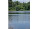 Scenic lake view surrounded by lush greenery and reflected clouds at 2527 Amalfi Dr, Conyers, GA 30012