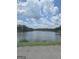 Picturesque lake view with trees in the background and clouds in the sky at 2527 Amalfi Dr, Conyers, GA 30012
