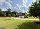 Back of home with a three car garage and a well-manicured lawn at 116 Standford Dr, Mcdonough, GA 30252