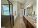 Bathroom with dual vanities, granite countertops, separate shower, and a soaking tub by a window at 116 Standford Dr, Mcdonough, GA 30252