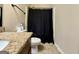 Bathroom features a toilet, a sink, and a shower with a black curtain at 116 Standford Dr, Mcdonough, GA 30252