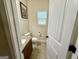 Cozy powder room with a granite countertop vanity and white beadboard door at 116 Standford Dr, Mcdonough, GA 30252