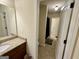 Bathroom with tiled floors and granite vanity leading to the shower with black shower curtain at 116 Standford Dr, Mcdonough, GA 30252