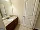 This bathroom features a granite countertop on the vanity, a sink and a white door at 116 Standford Dr, Mcdonough, GA 30252