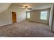 Large bonus room bathed in natural light with two windows and neutral colored walls and carpet at 116 Standford Dr, Mcdonough, GA 30252