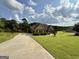 Long driveway with a view of the front exterior of the home at 116 Standford Dr, Mcdonough, GA 30252