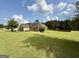 Spacious front yard showcasing landscaping and a well-maintained lawn of this charming home at 116 Standford Dr, Mcdonough, GA 30252