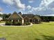 Charming one-story home with well-manicured lawn, lush landscaping, and beautiful brickwork at 116 Standford Dr, Mcdonough, GA 30252