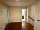Hallway leading to bathroom featuring hardwood floors and white trim at 116 Standford Dr, Mcdonough, GA 30252